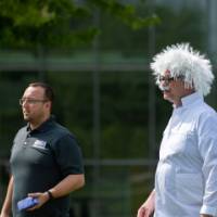 A staff member dressed like Einstein looks on during the tournament